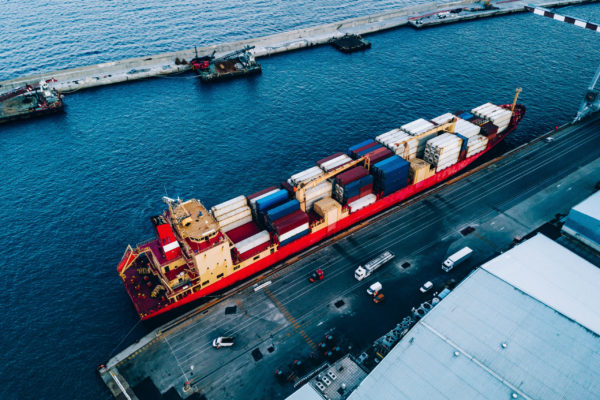 Aerial top view of industrial cargo container logistics ship in terminal in Italy