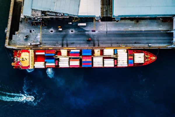 Aerial top view of container ship at sea port